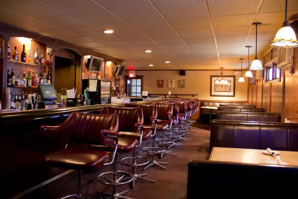 Booths and barstools inside Dino's Restaurant