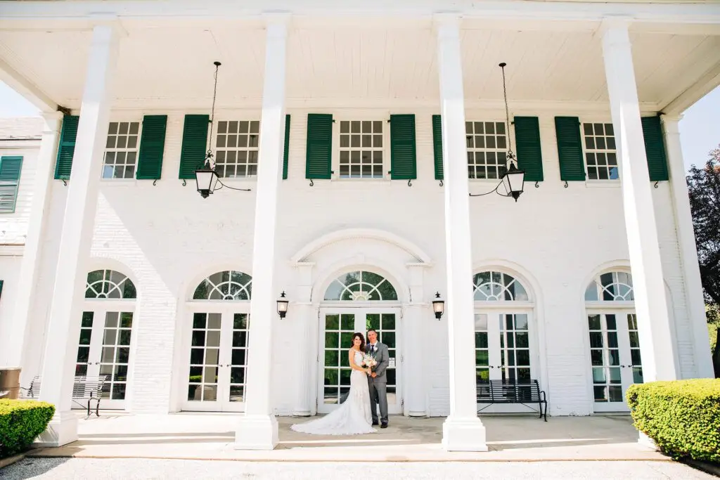 Newly wed couple standing in front of building at Manakiki